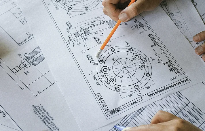 Hands reviewing architectural blueprints