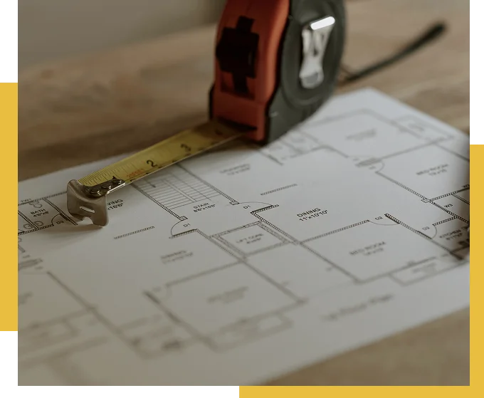 Tape measure placed over a residential floor plan