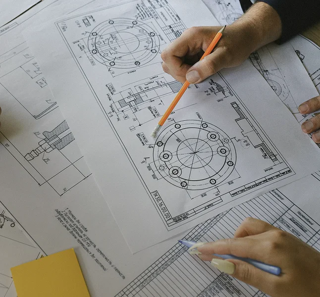 Hands reviewing and marking a residential floor plan